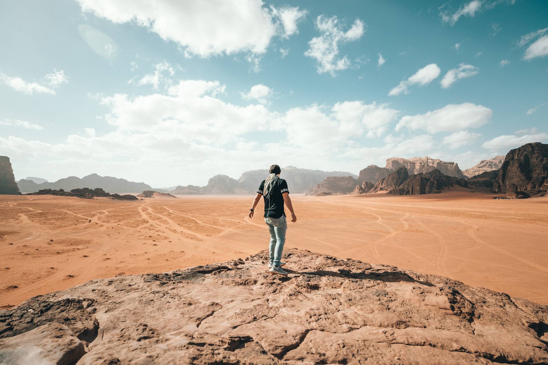 traveler exploring rocky arid terrain during vacation