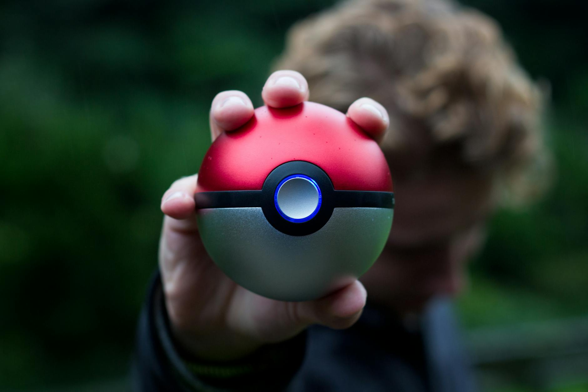 person holding pokemon ball toy