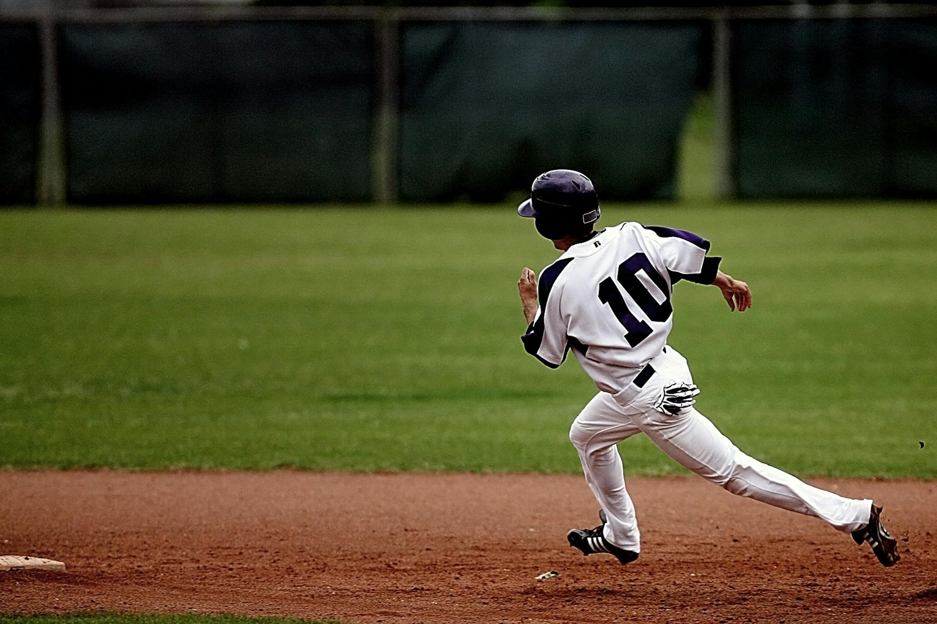 baseball player running on court