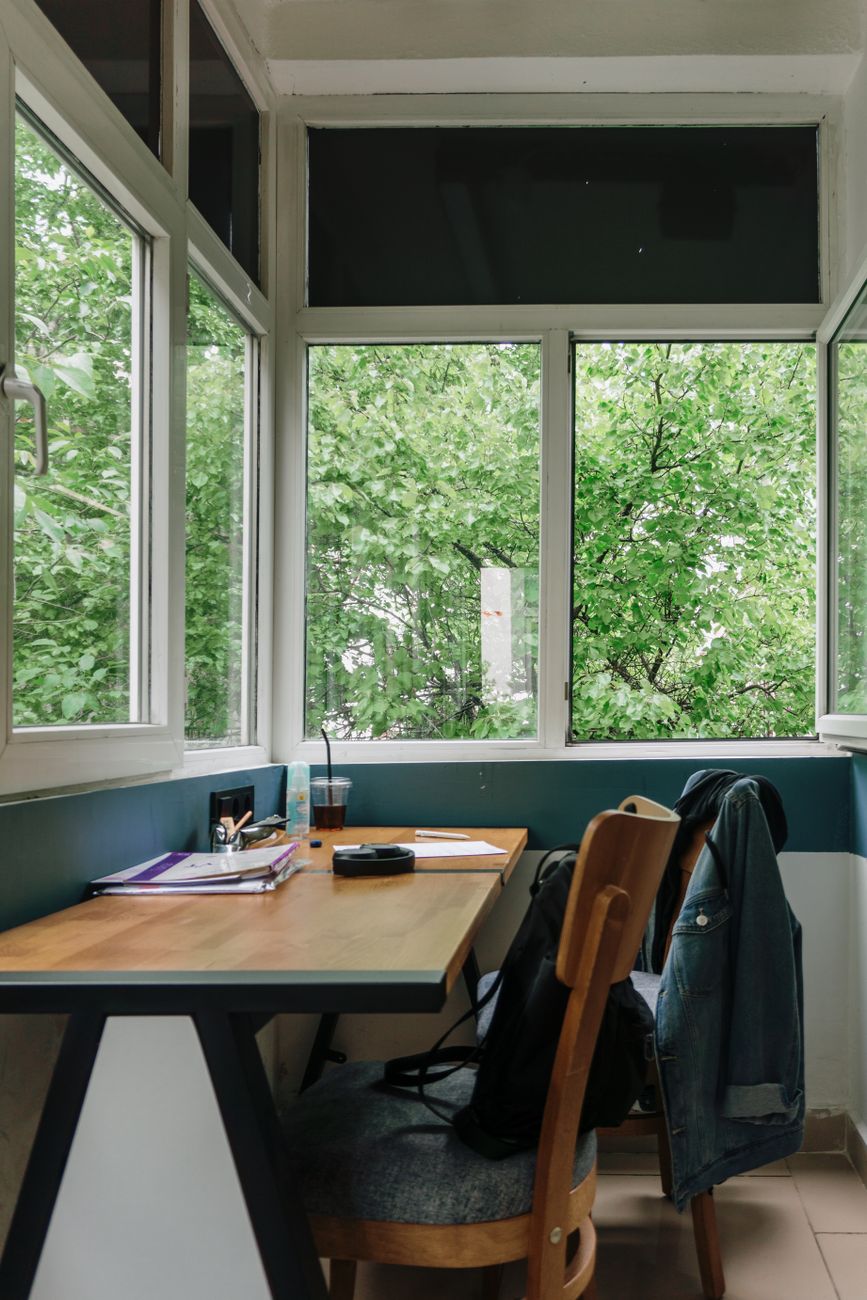 desk and chairs near windows
