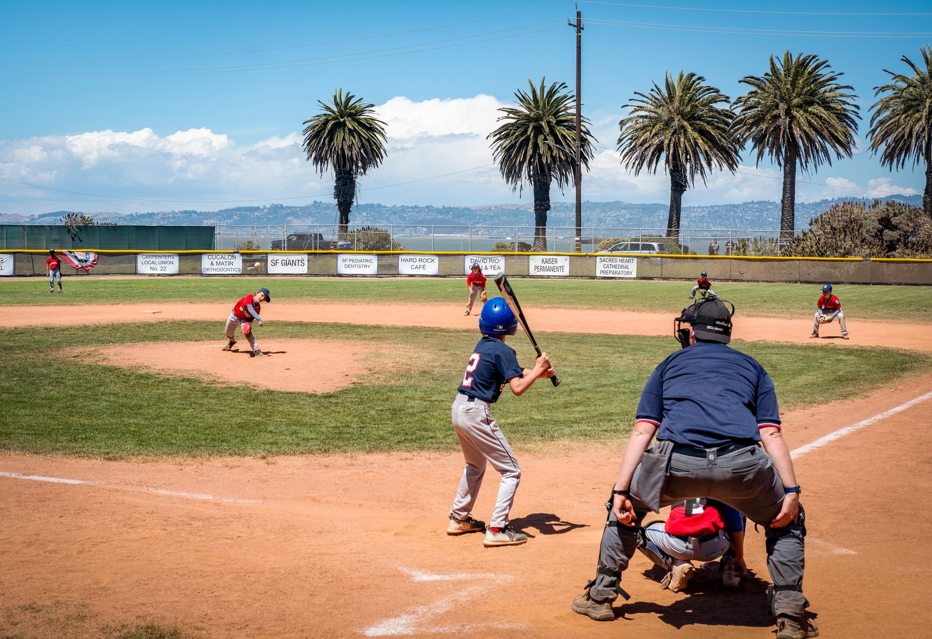 children playing baseball on field